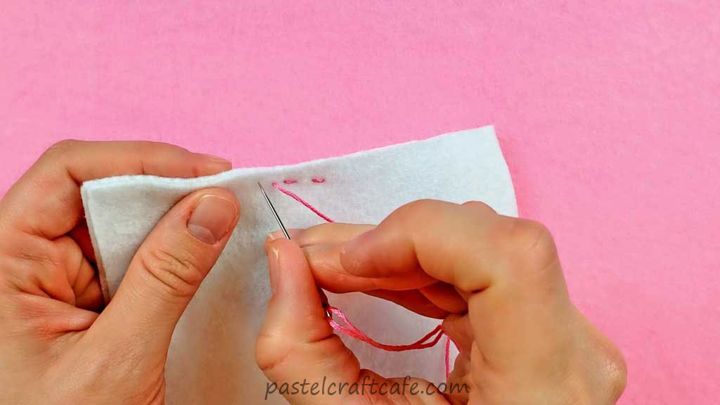 Two pieces of felt attached with two stitches of the running stitch