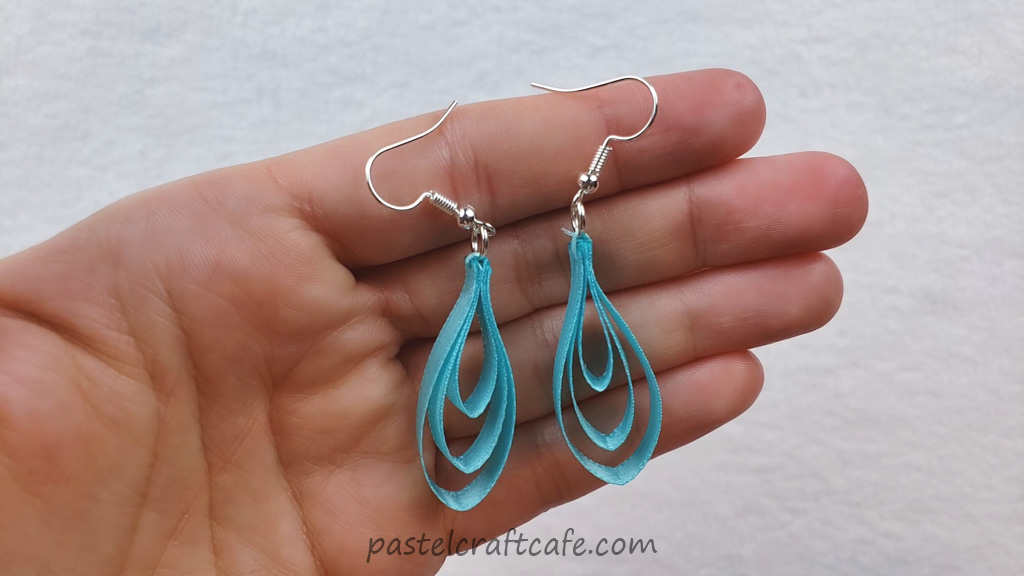A set of finished blue tiered ribbon earrings
