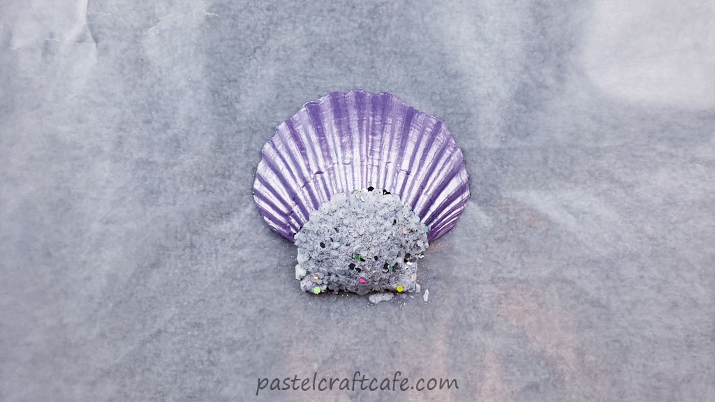Fine silver holographic glitter sprinkled over wet Mod Podge on a purple seashell