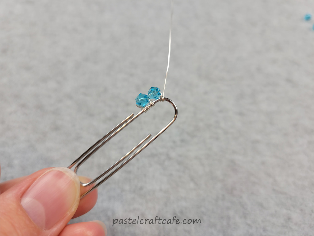 Two 4mm beads attached to the top of a paperclip with wire