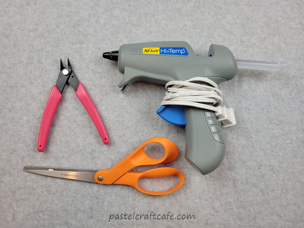 A button shank remover, a glue gun, and scissors