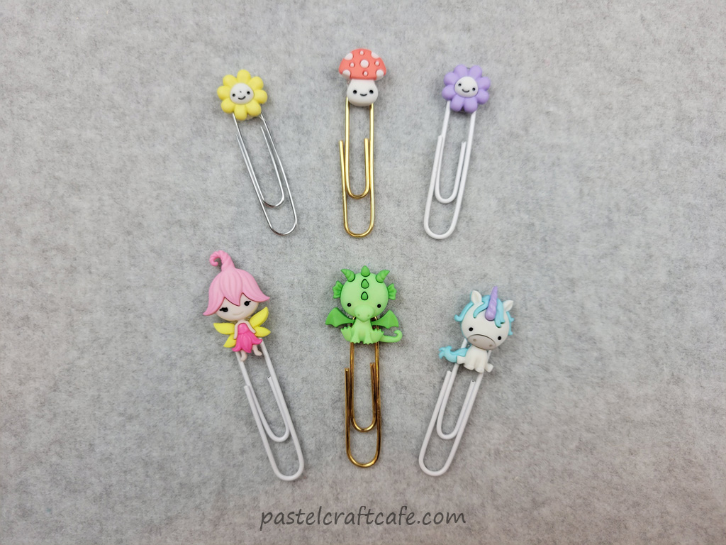 Six button paperclip bookmarks with different fantasy characters attached to the tops of the paperclips