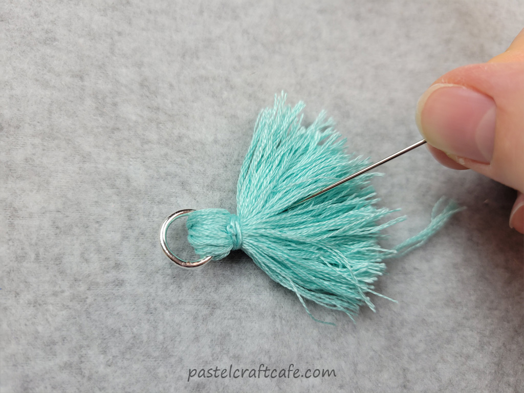 Needle combing through threads of tassel