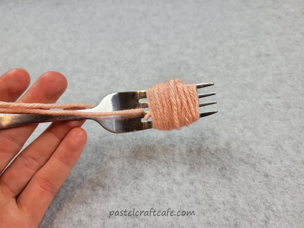 A bundle of yarn wound around a fork