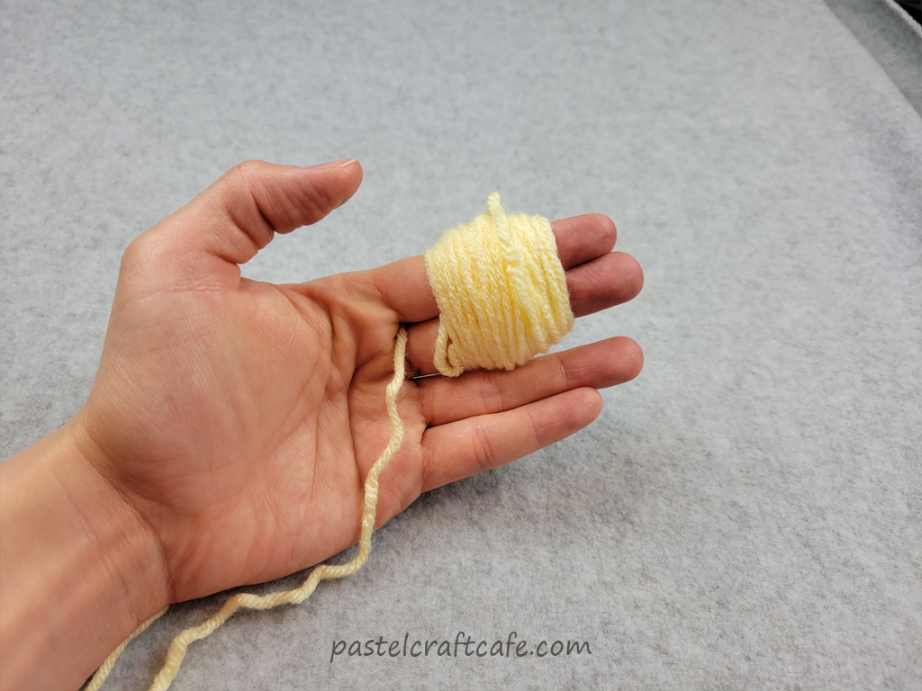 A bundle of yarn wrapped around two fingers