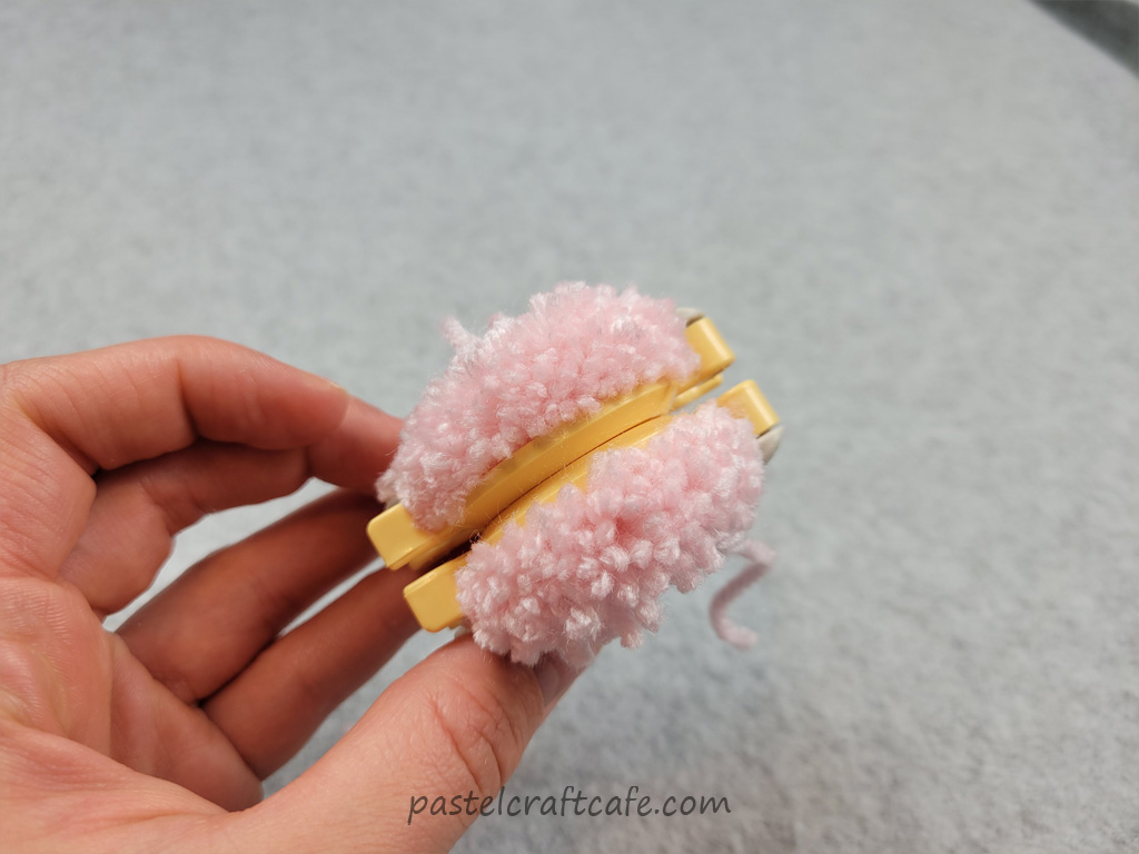 A pom pom maker that has been cut all the way around