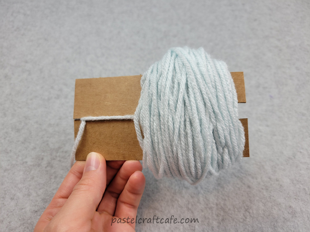 A pom pom rectangle template full of yarn