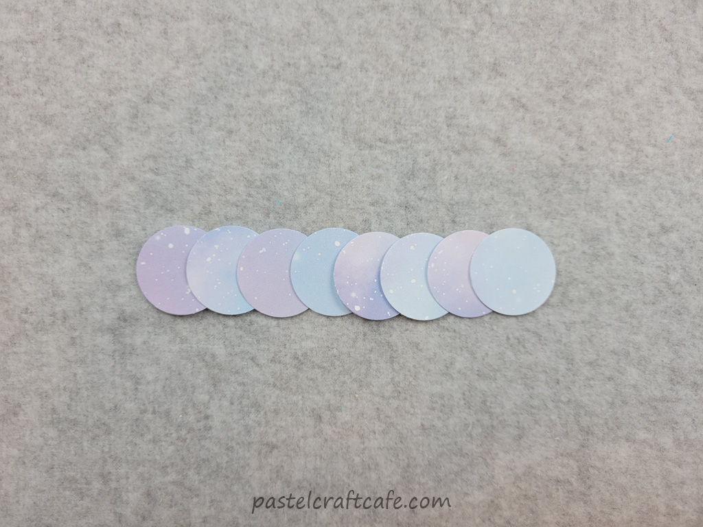 Eight circles punched from patterned scrapbook paper