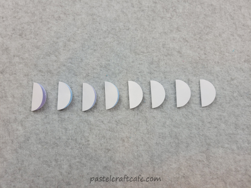 Eight folded circles of scrapbook paper