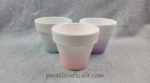 Three ombre dip dyed pots in pink, purple, and teal
