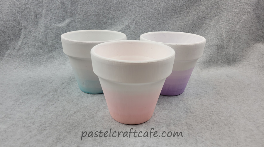 Three ombre dip dyed pots in pink, purple, and teal