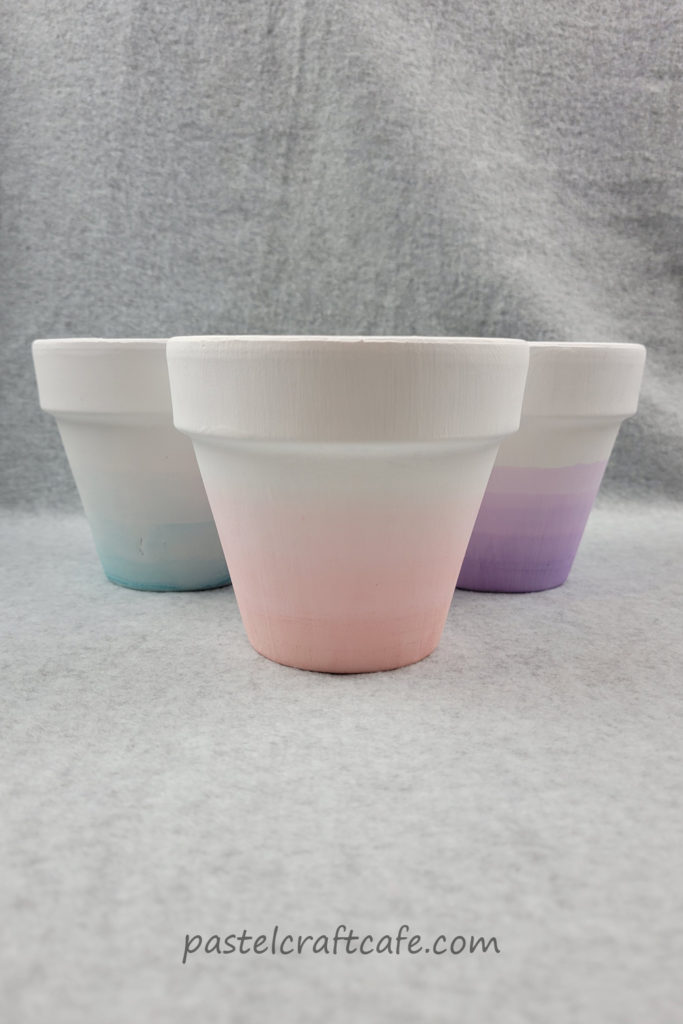 Three ombre dip dyed pots arranged in a triangle