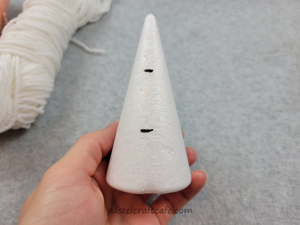 A styrofoam cone with marker lines dividing it into three sections
