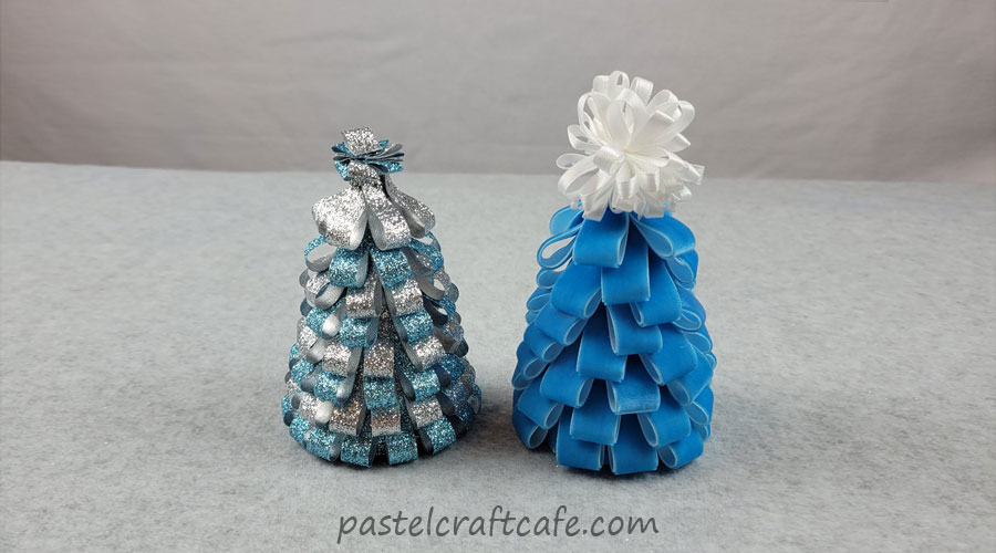 Two ribbon christmas trees, one made of blue and silver glitter ribbon and the other made of blue velvet ribbon