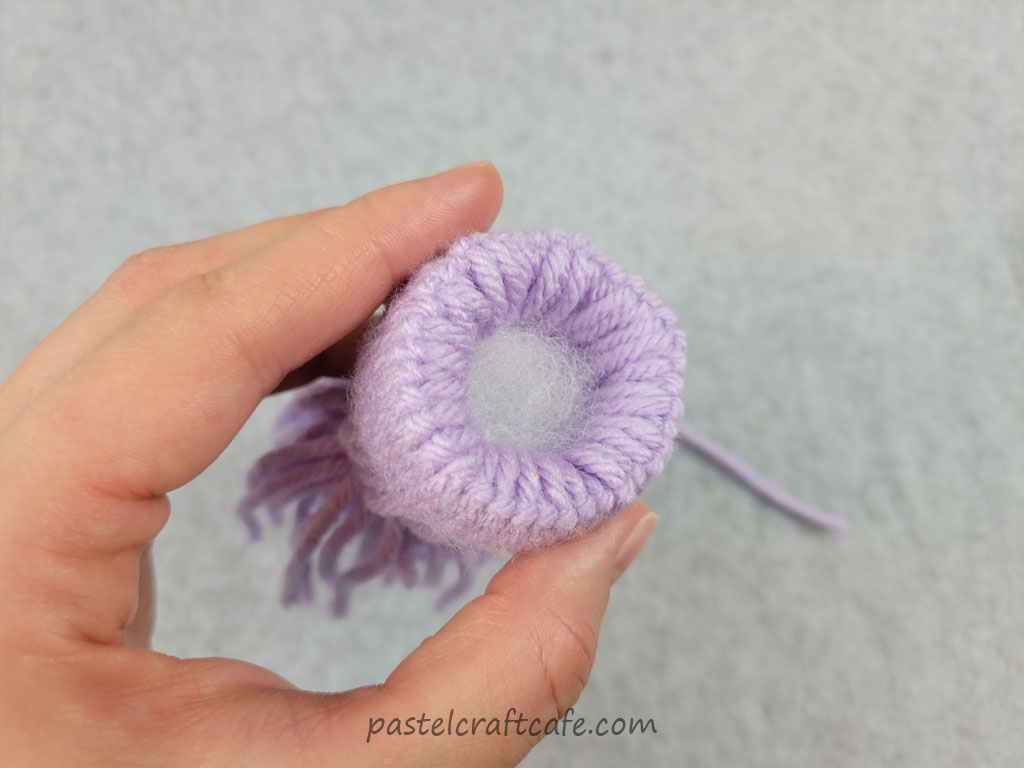 A mini yarn hat stuffed at the bottom to give the hat the correct shape