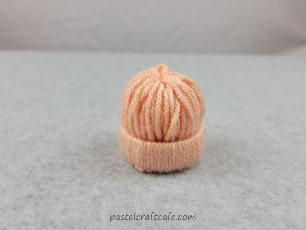 Orange yarn bundled together to form a dome shape