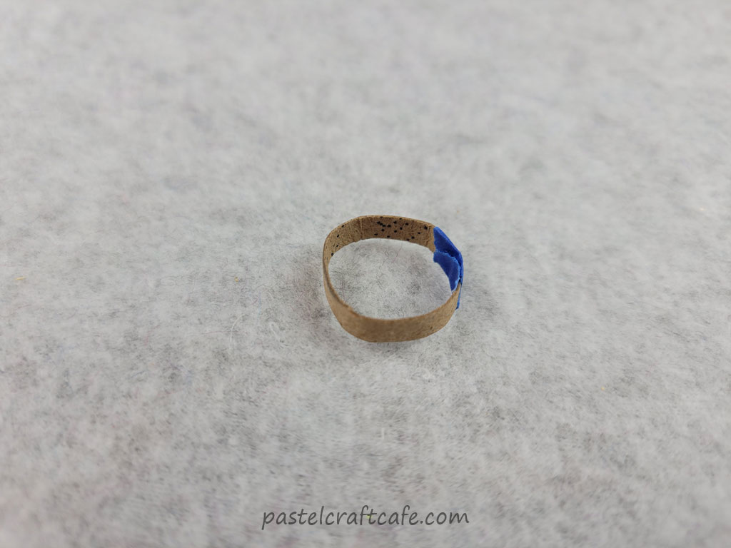A tiny piece of cardboard shaped into a ring