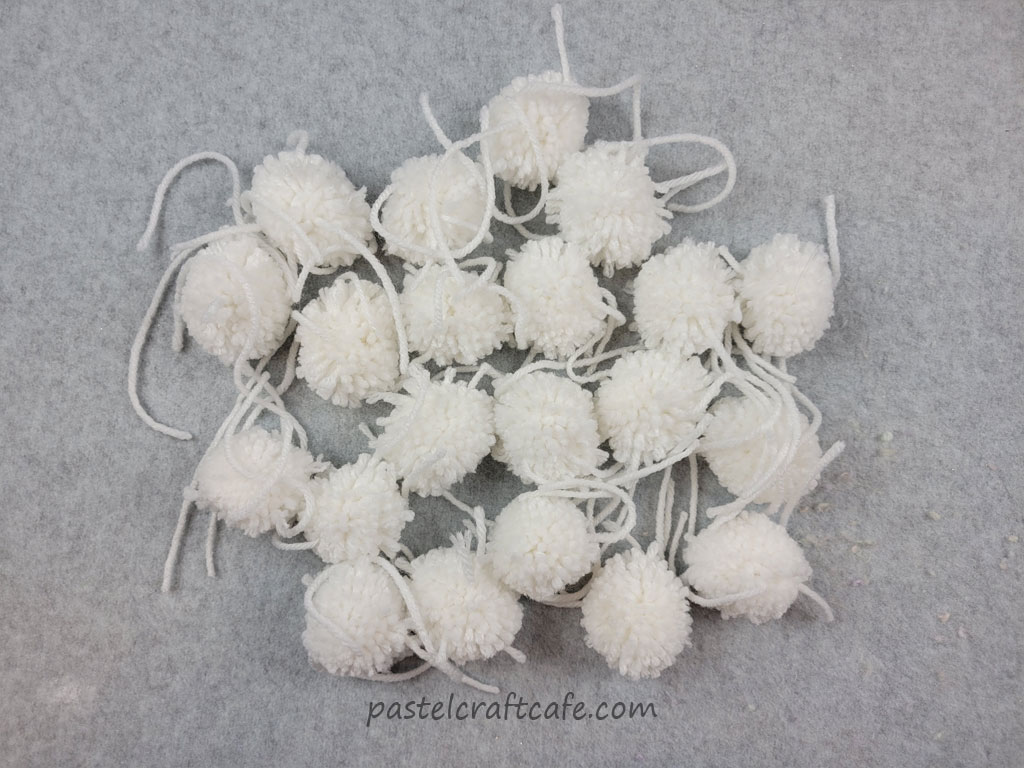 A pile of small and messy white pom poms