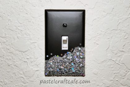 An elegant glitter lightswitch plate attached to the wall