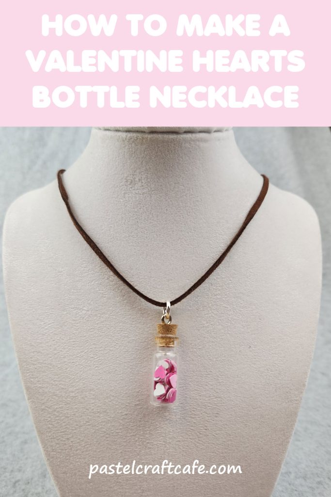 The words "How to make a Valentine Hearts Bottle Necklace" above a necklace with a bottle charm that is filled with paper hearts hanging on a jewelry bust stand
