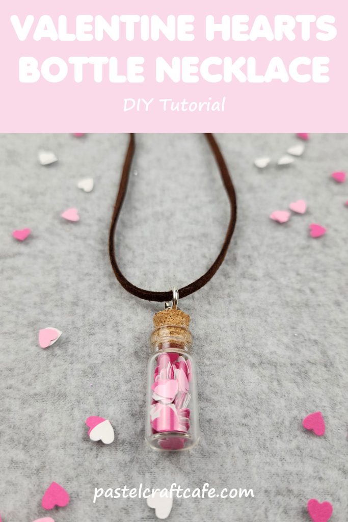 Words "Valentine Hearts Bottle Necklace DIY Tutorial" above a necklace with a bottle charm that is filled with paper hearts. More paper hearts are scattered around the necklace